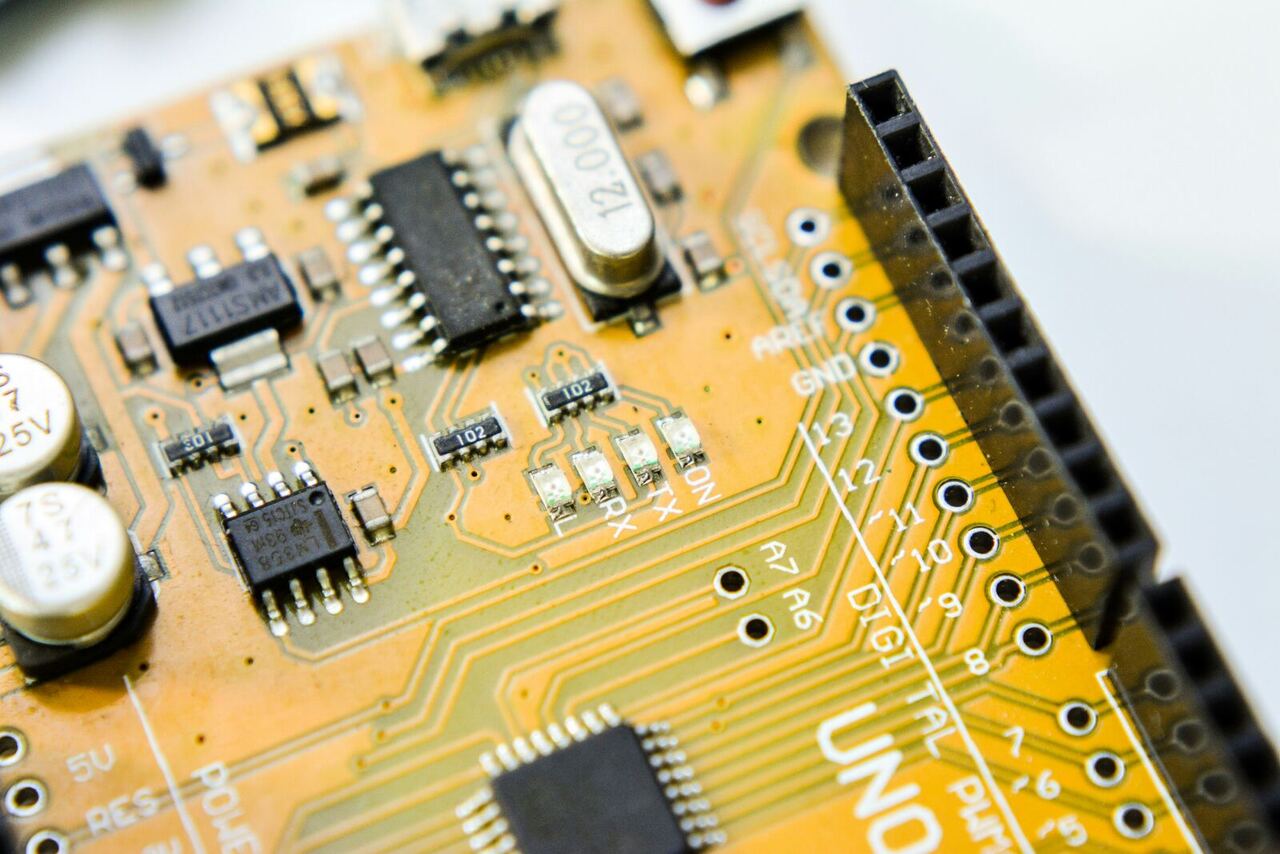 Macro shot of an electronic printed circuit board, representing digital transformation and AI management systems