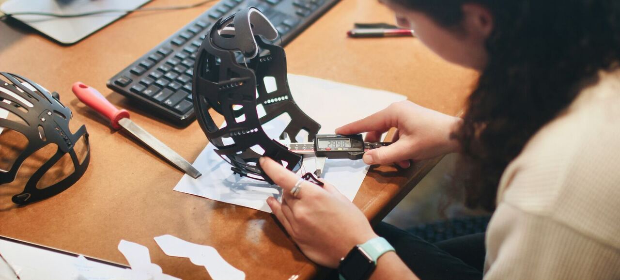 Hands finishing and assembling a 3D-printed prototype